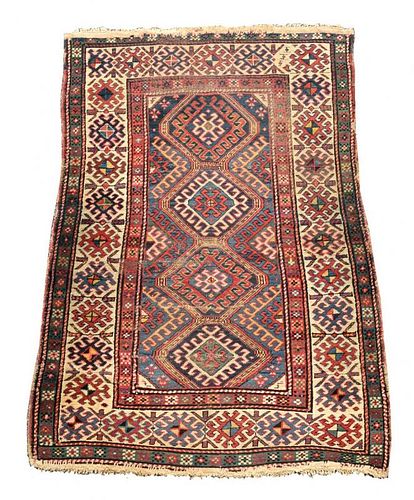 A Caucasian rug, 187 x 113cm (73 x 44in) <br. <br>Worn with low pile, ridging, border losses and bin