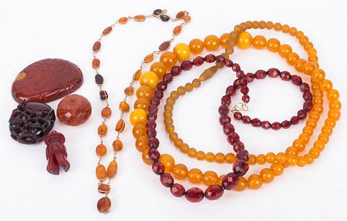 A Bag Of Amber Jewelry and Carvings