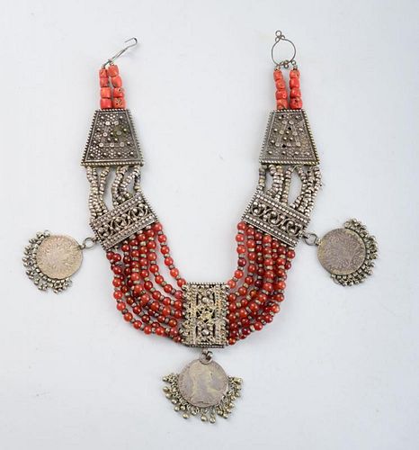 NORTH AFRICAN SILVERED METAL, AMBER-GLASS AND CORAL BEADED NECKLACE, HUNG WITH THREE AUSTRIAN COINS