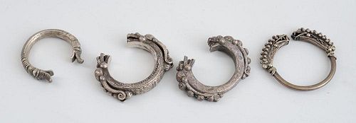 FOUR ASIAN SILVERED METAL BANGLE BRACELETS WITH DRAGON HEADS