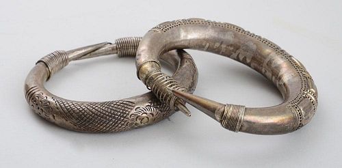 TWO ENGRAVED METAL BRACELETS WITH COILED ENDS