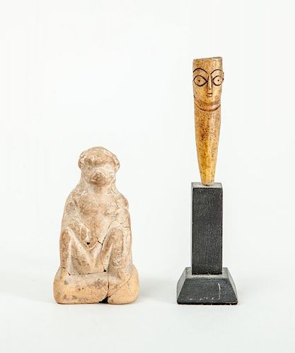 ROMAN TERRACOTTA FIGURE OF A SEATED MONKEY AND A ROMAN CARVED BONE DOLL