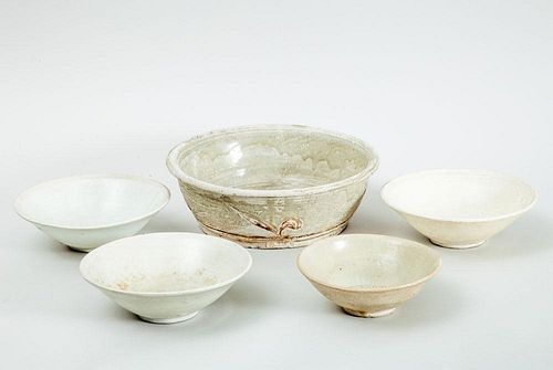 GROUP OF FOUR CREAM-GLAZED BOWLS AND A SHALLOW BOWL