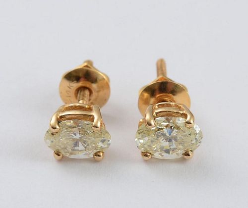 PAIR OF 14K GOLD AND OVAL DIAMOND STUD EARRINGS