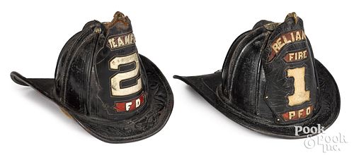 Two painted leather fire helmets, 19th c.