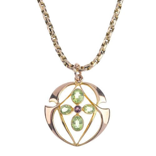 An early 20th century gem-set pendant. The circular-shape garnet, within an oval-shape peridot quatr