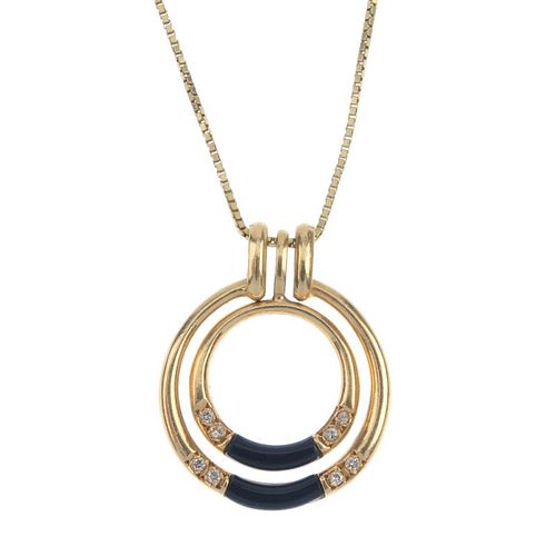 An onyx and diamond pendant. Designed as two concentric tapered circles, each with onyx curved panel