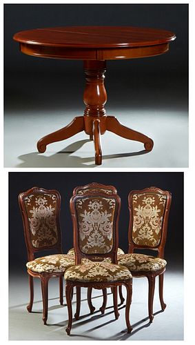 French Provincial Carved Cherry Five Piece Dining Room Suite, consisting of a circular table with a wide skirt, on a turned support on four scrolled c