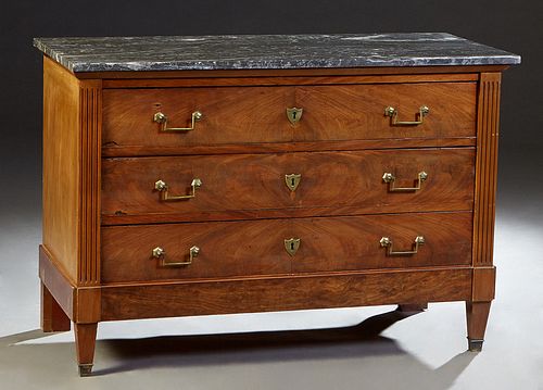 French Louis XVI Style Carved Mahogany Marble Top Commode, early 20th c., the highly figured gray marble over three setback deep drawers flanked by re