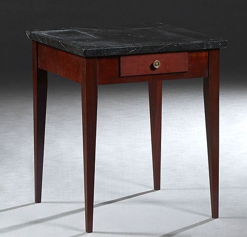 Louis XVI Style Carved Mahogany Marble Top Lamp Table, 20th c., custom made, the figured black marble over a wide skirt with one frieze drawer, on tap