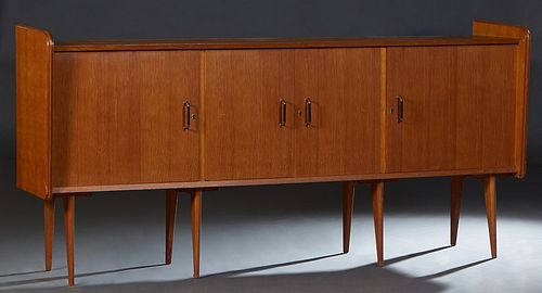 French Mid-Century Modern Carved Oak Sideboard, 20th c., the rectangular top over double cupboard doors, flanked by large cupboard doors, on a plinth 