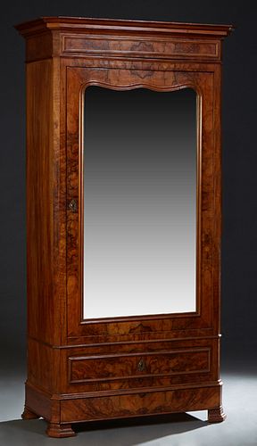 French Louis Philippe Carved Walnut Armoire, 19th c., the stepped canted crown over a large mirror door, above a lower drawer and a bottom "secret" dr