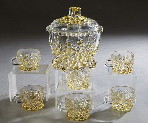 French Seven Piece Molded Yellow and Clear Glass Punch Set, 20th c., consisting of a covered punch bowl with relief grape decoration and 6 matching cu