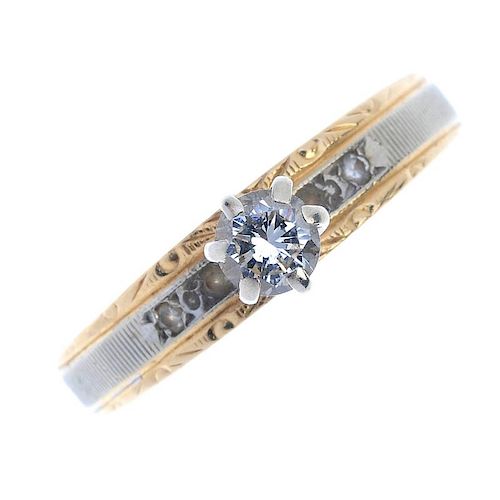 A diamond single-stone ring. The brilliant-cut diamond, raised to the bi-colour and vari-texture ban