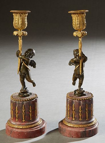 Pair of Gilt and Patinated Bronze and Marble Figural Candlesticks, 19th c., the gilt candle cup upheld by a patinated winged putto, on a stepped gilt 