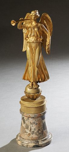 Continental School, "Trumpeting Angel," 19th c., gilt bronze mounted on a cylindrical stepped gray breche d'Alpes base, H.- 18 1/2 in., W.- 4 1/2 in.,