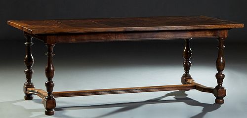 French Carved Oak Louis XVI Style Dining Table, early 20th c., the rounded corner rectangular top over a wide skirt, on turned and block legs joined b
