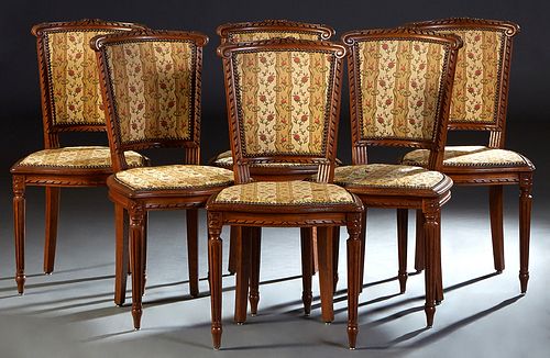 Set of Six French Carved Oak Louis XVI Style Dining Chairs, 20th c. the canted curved floral carved crest rail over an upholstered back to a shield sh