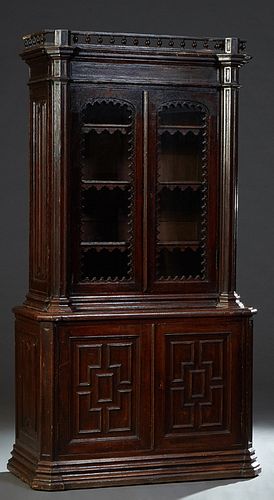 English Carved Oak Bookcase Cupboard, late 19th c. the spindled crown over double setback glazed doors, flanked by engaged hexagonal pilasters, on a c