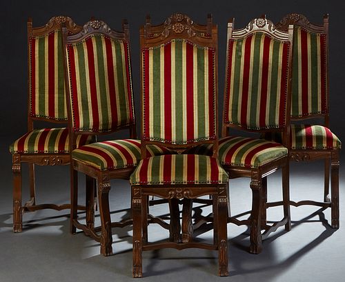 Set of Six Spanish Renaissance Style Dining Chairs, 20th c., the tall arched floral carved canted upholstered back, over a trapezoidal cushioned seat,