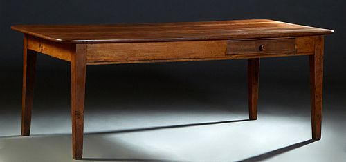 French Provincial Carved Oak Farmhouse Table, 19th c., the rounded corner four board top over a wide skirt, with a frieze drawer on one long side, on 