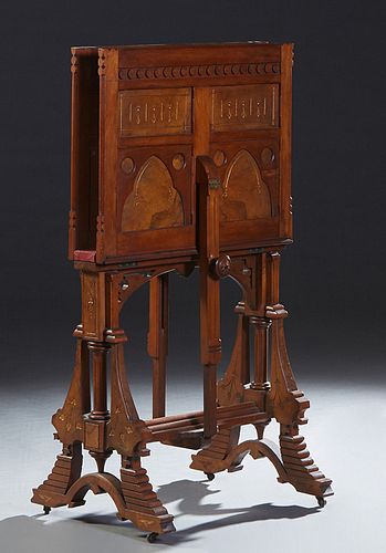 American Modern Gothic Gilt Incised Burled Walnut and Walnut Folio Stand, late 19th c., the paneled and hinged end boards adjusted by a turned knob on
