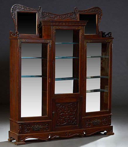 American Carved Oak Arts and Crafts Three Door Side-by-Side China Cabinet, c. 1910, with a central incise carved back rail, over a long center glazed 