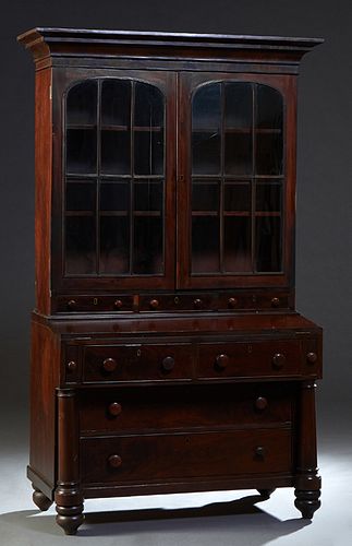 Americana Classical Carved Mahogany Secretary Bookcase, 19th c., the stepped ogee crown over double arched glazed mullioned doors above three shallow 