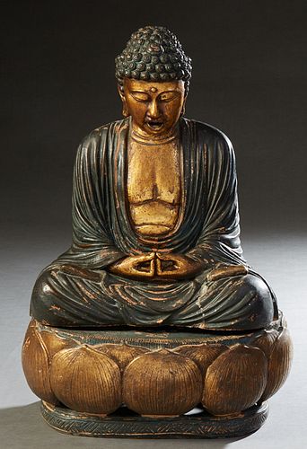 Chinese Patinated and Gilt Decorated Terracotta Seated Buddha, 19th c., on a gilt lotus dais, H.- 22 in., W.- 15 in., D.- 11 1/2 in. Provenance: The C