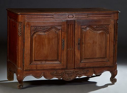 French Provincial Carved Cherry Louis XV Style Sideboard, 19th c., the stepped rounded edge and corner three board top over setback double fielded pan