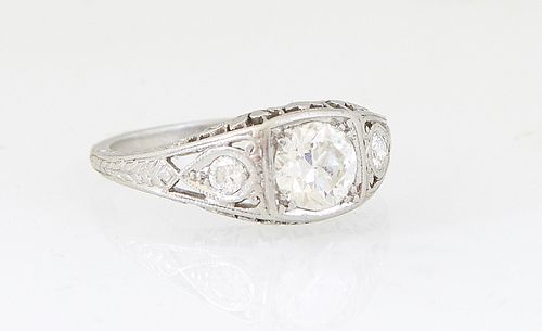 Lady's Vintage Platinum Dinner Ring, with a circular 1.0 carat round diamond, flanked by lugs with two 10 point round diamonds, Total Diamond Wt.- 1.2