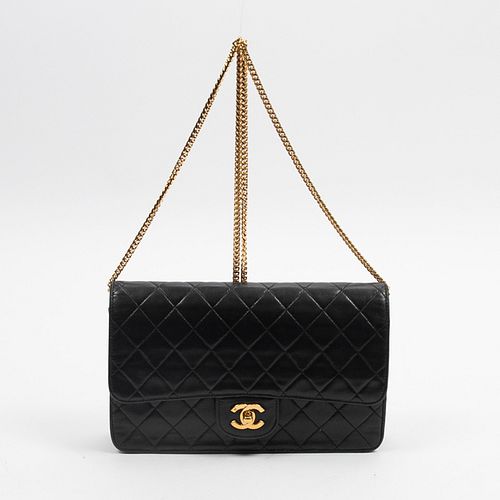 Chanel Classic Single Flap, c. 1986, in black quilted lambskin leather with golden hardware, opening to a black and burgundy lined leather interior wi