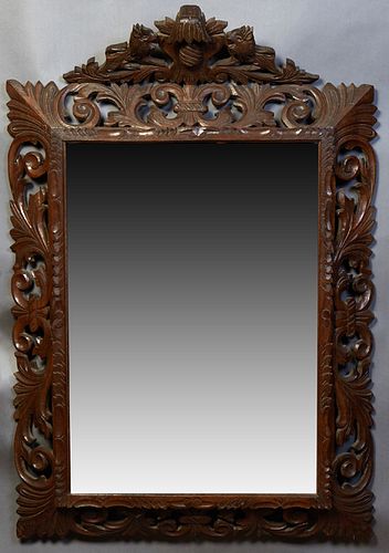 French Henri II Style Carved Beech Cushion Mirror, early 20th c, with a lion and egg carved crest above a pierced leaf and scroll frame around a wide 