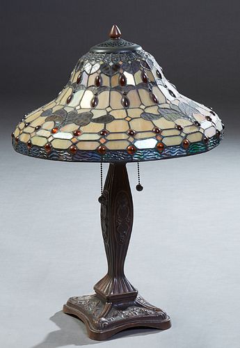 Tiffany Style Table Leaded Glass Lamp, late 19th c., the tapered circular shade with amber cabochon jewels, on a brown patinated tapered support, with