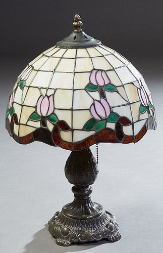 Diminutive Tiffany Style Table Lamp, late 20th c., the tapered scalloped leaded glass domed shade with floral and leaf decoration, on a tapered patina