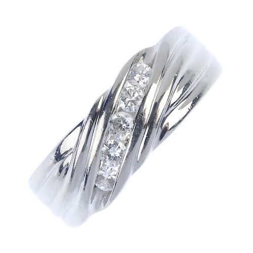 A platinum diamond dress ring. The brilliant-cut diamond diagonal line, with grooved sides and taper