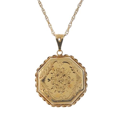 A 9ct gold locket. Of hexagonal outline, with engraved floral and foliate motif, to the rope-twist s