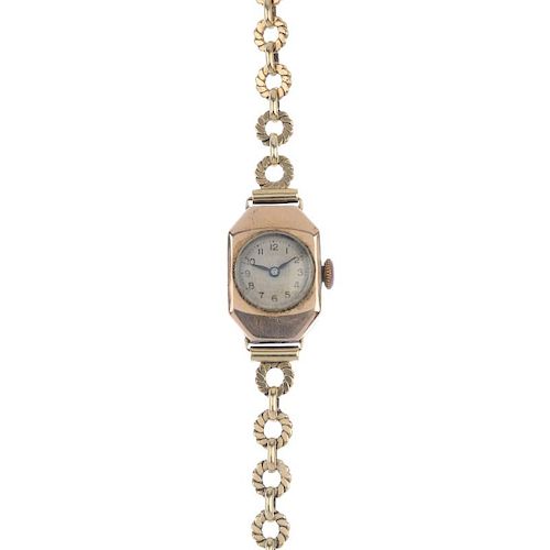 A ladies mid 20th century 9ct gold manual wind bracelet watch. The circular-shape Arabic dial, withi