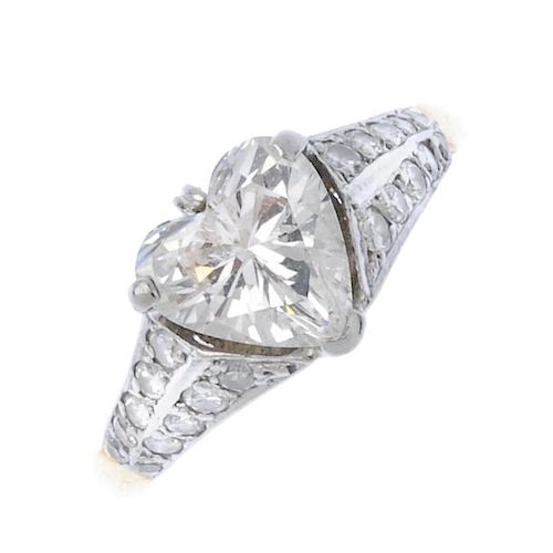 (187921) An 18ct gold diamond single-stone ring. The heart-shape diamond to the graduated brilliant-