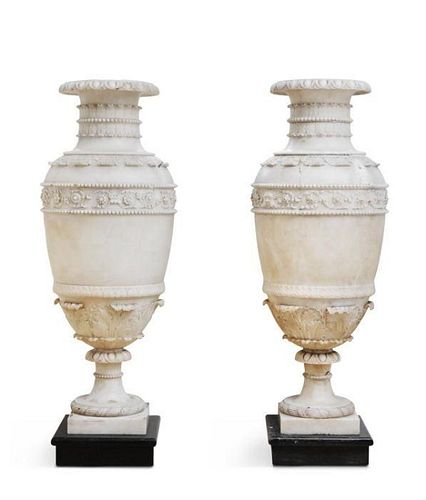 A PAIR OF CARVED ALABASTER URNS, 19TH CENTURY, IN THE