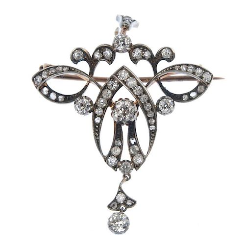 A late 19th century silver and 9ct gold diamond pendant. The three old-cut diamonds, within an old a
