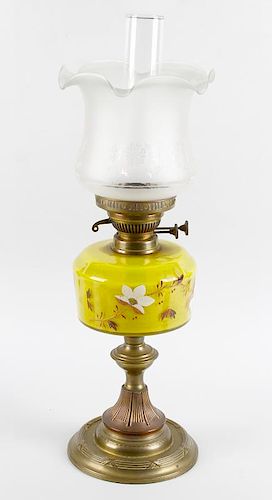 Two brass paraffin lamps, circa 1900, the first with frosted bell shaped shade over duplex burner, p