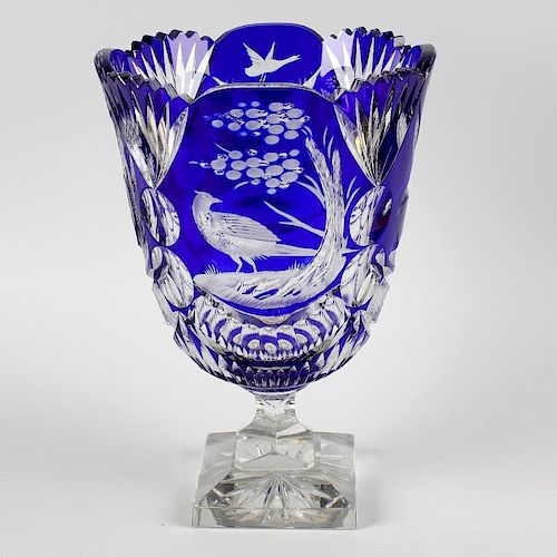 A heavy cut glass vase, the flash cut, blue overlaid glass bowl with frilled collar and bird decorat