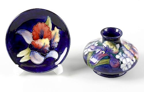 Two items of Moorcroft Orchid pattern pottery. Comprising: a vase, of squat bulbous form on dark blu