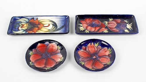 Four items of Moorcroft pottery. Comprising: two small shallow Clematis pattern circular dishes, the