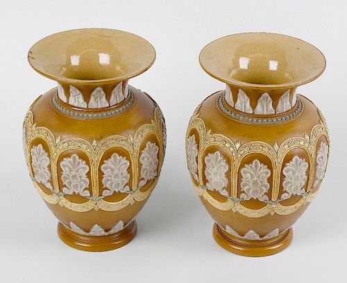 A pair of Doulton Lambeth silicone ware vases. Each of ovoid form with flared neck, having raised fo
