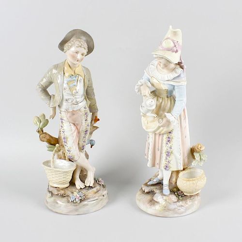 A pair of German bisque figures. Modelled as a male and female each stood upon a naturalistic ground
