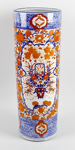 A Japanese porcelain stick stand. Of cylindrical form decorated in Imari colours with vase of flower