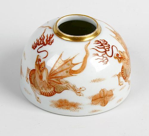 A Chinese porcelain brush pot or taibaizan. Of hemispherical form painted in burn orange with dragon