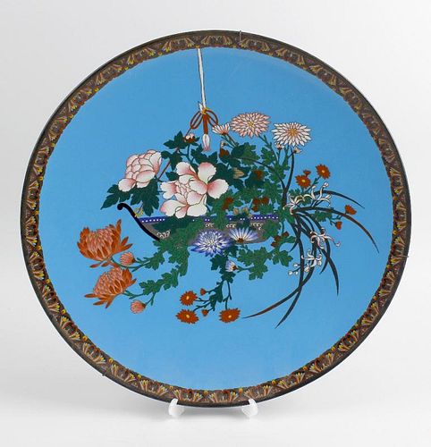A large Japanese cloisonne charger, the blue coloured ground decorated with a basket of hanging flow